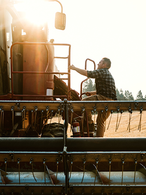 someone climbing into a combine