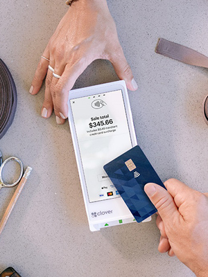 woman scanning her card in a POS