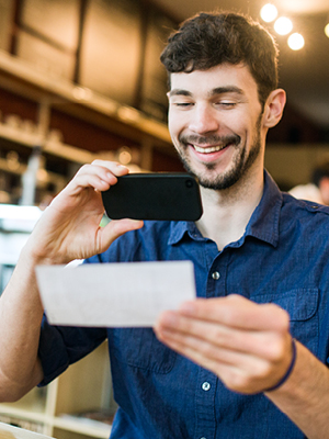 man taking a picture of his check