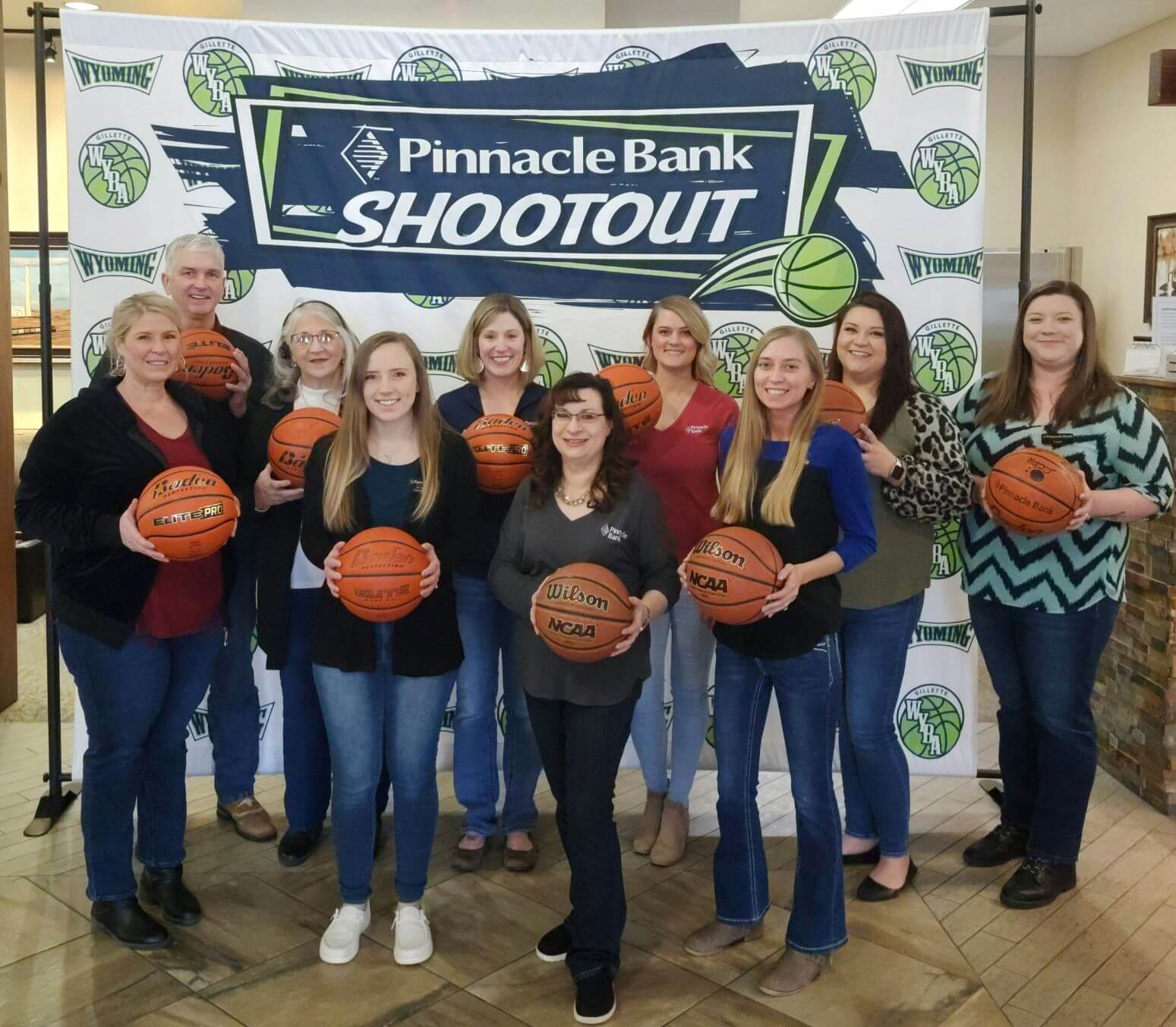 Group of people holding basketballs