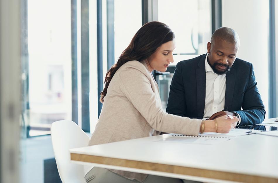man and woman working at a desk