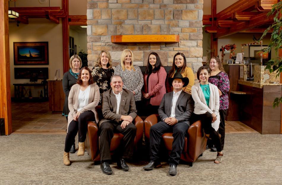 bank employees in front of a fireplace