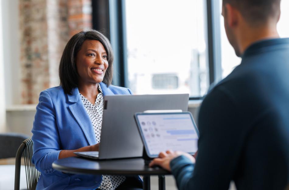 two people using laptop computers
