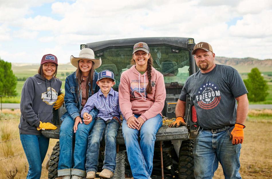 family sitting on the back of an ATV