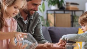 father and kids counting coins